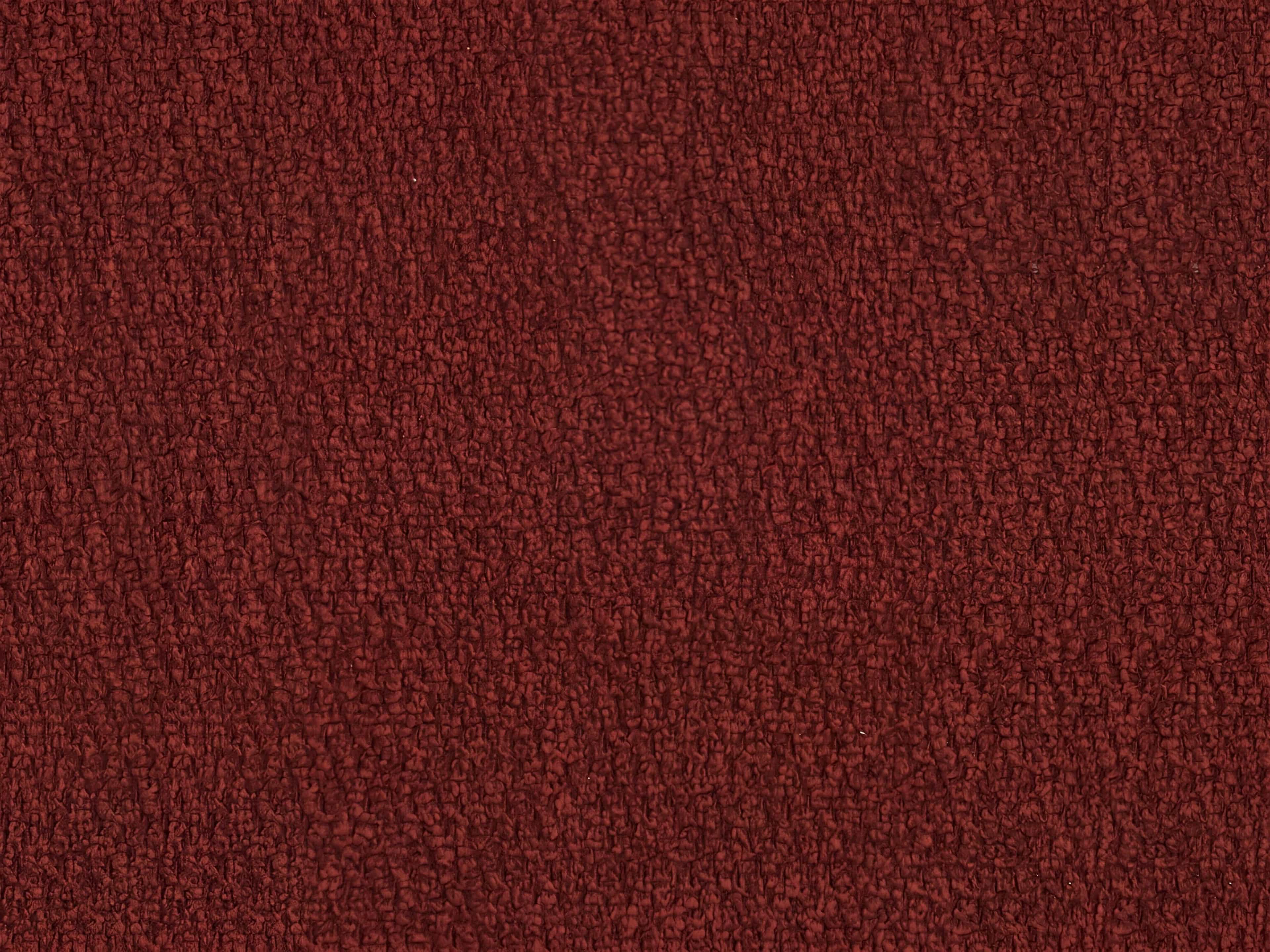Roter Stoffbezug mit strukturierter Oberfläche und gleichmäßiger Textur in Nahaufnahme.