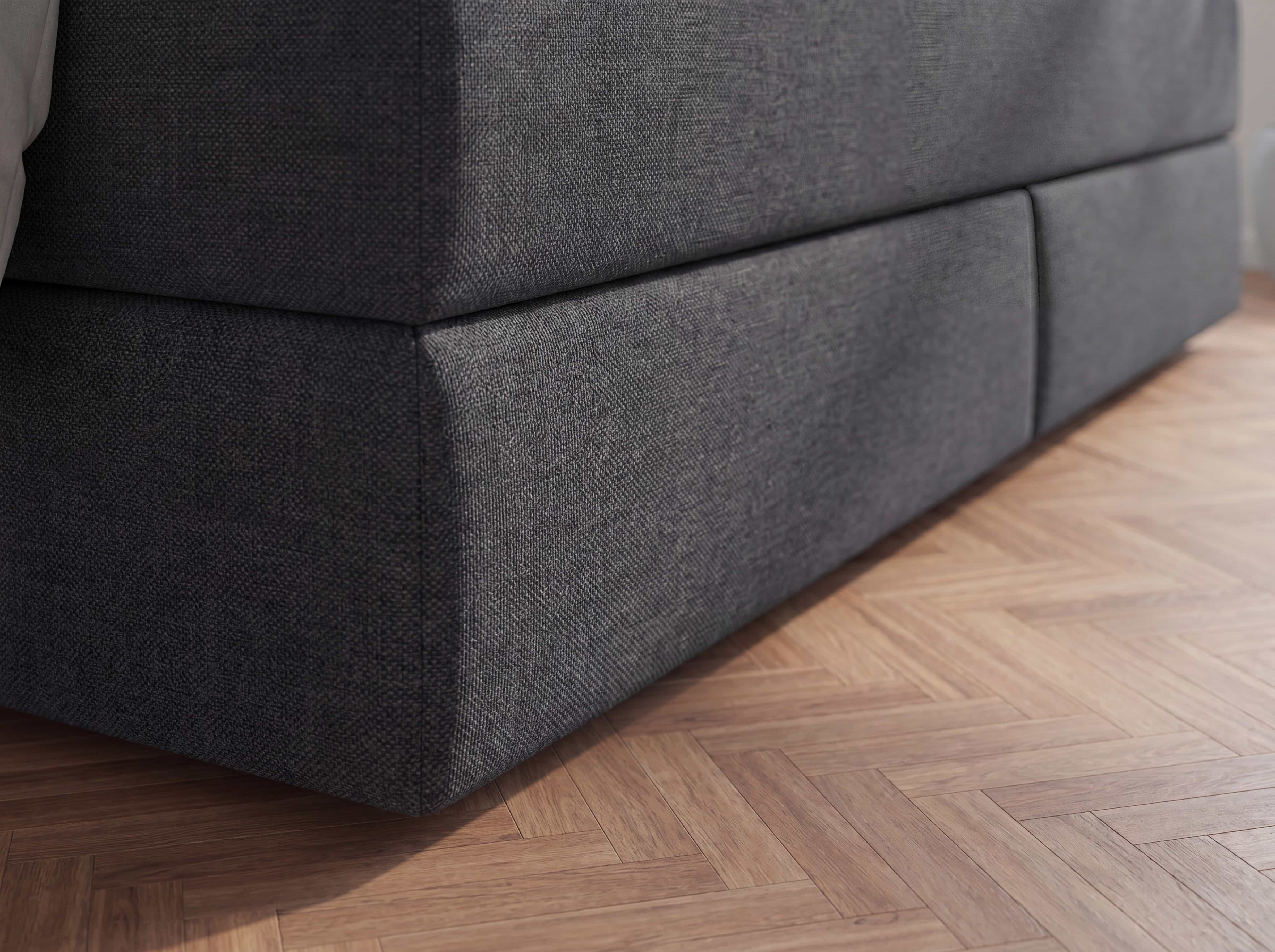 Boxspringbett mit dunkelgrauem Stoffbezug, gepolstertem Unterbau und geradliniger Form