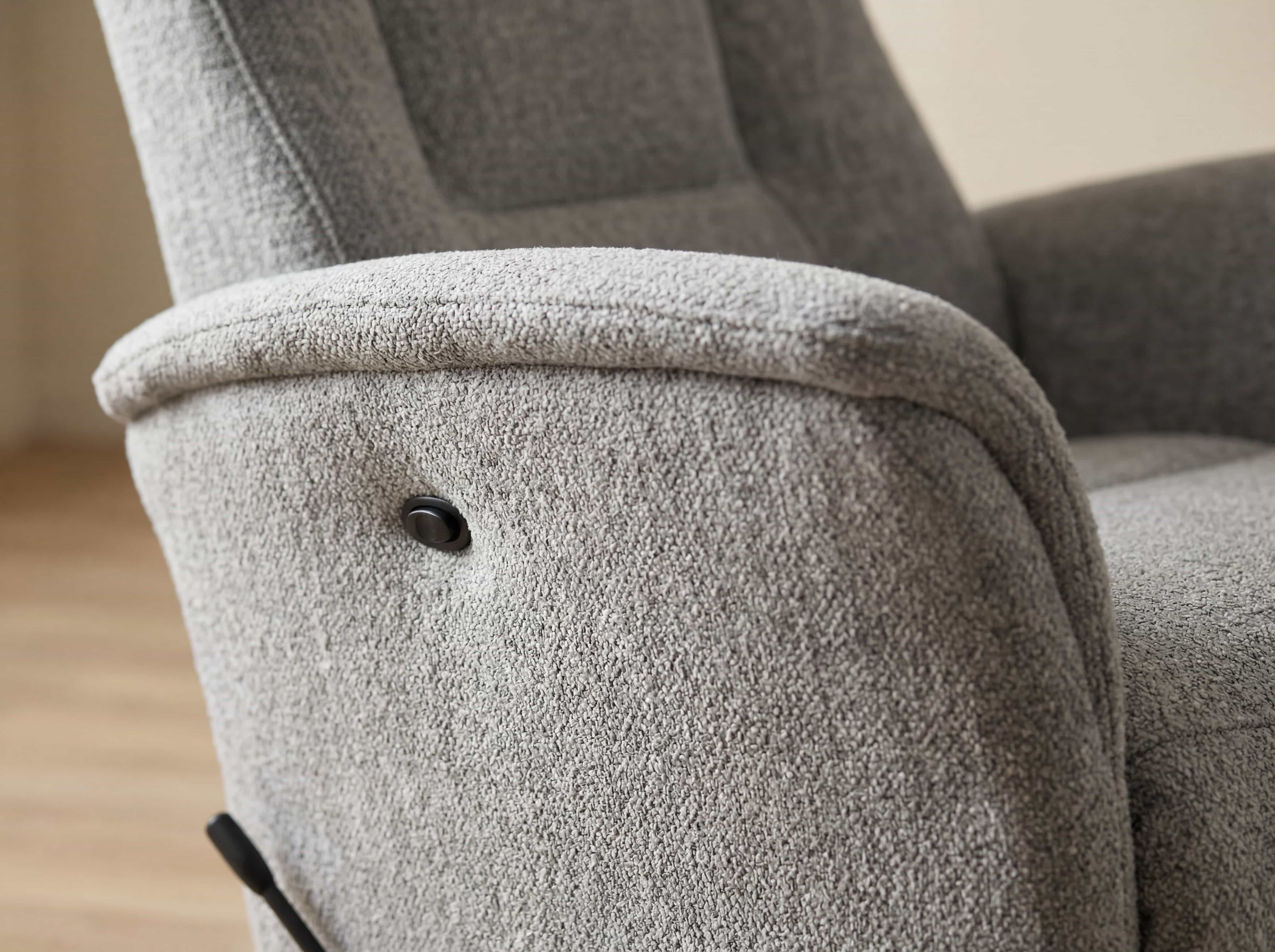 Relaxsessel Kalisso – Detailansicht des grauen Bouclébezugs mit Armlehne und sichtbarem Knopf