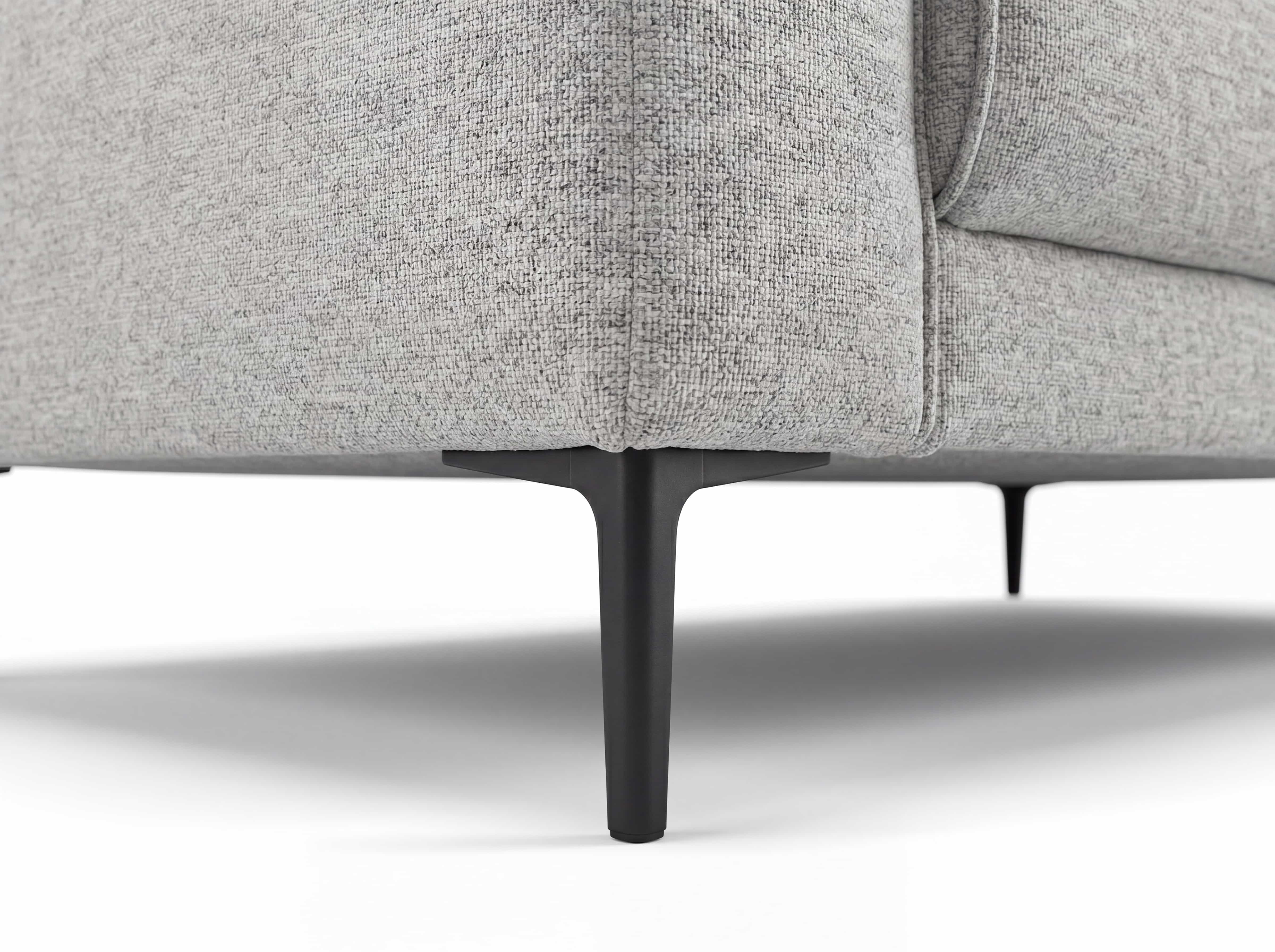 Ecksofa Kabs mit grauem Stoffbezug und schwarzen Metallfüßen in Nahaufnahme der Sofaecke