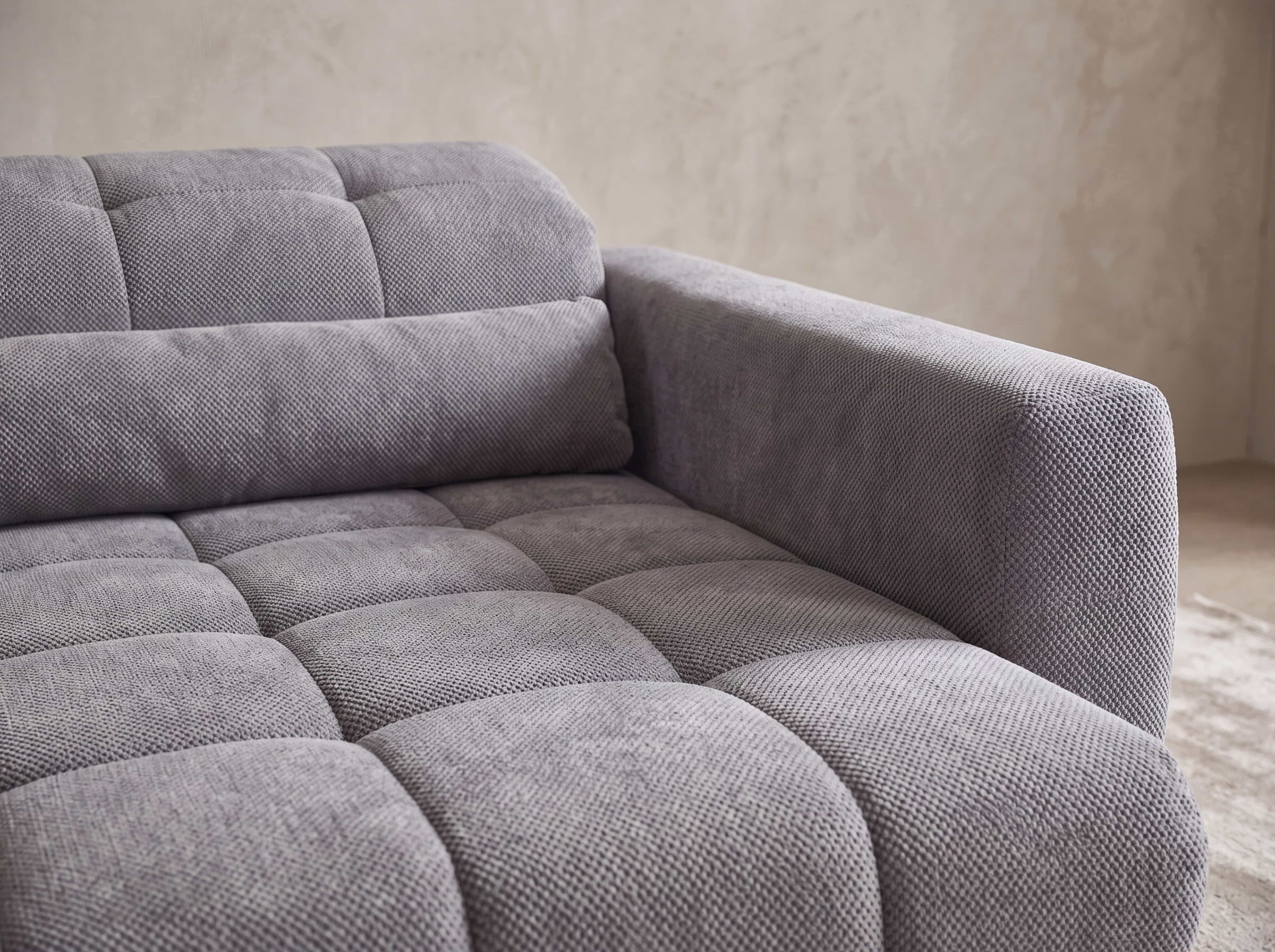 Ecksofa Kabs Polsterwelt mit grauem Stoffbezug, gepolsterter Sitzfläche und breiter Armlehne
