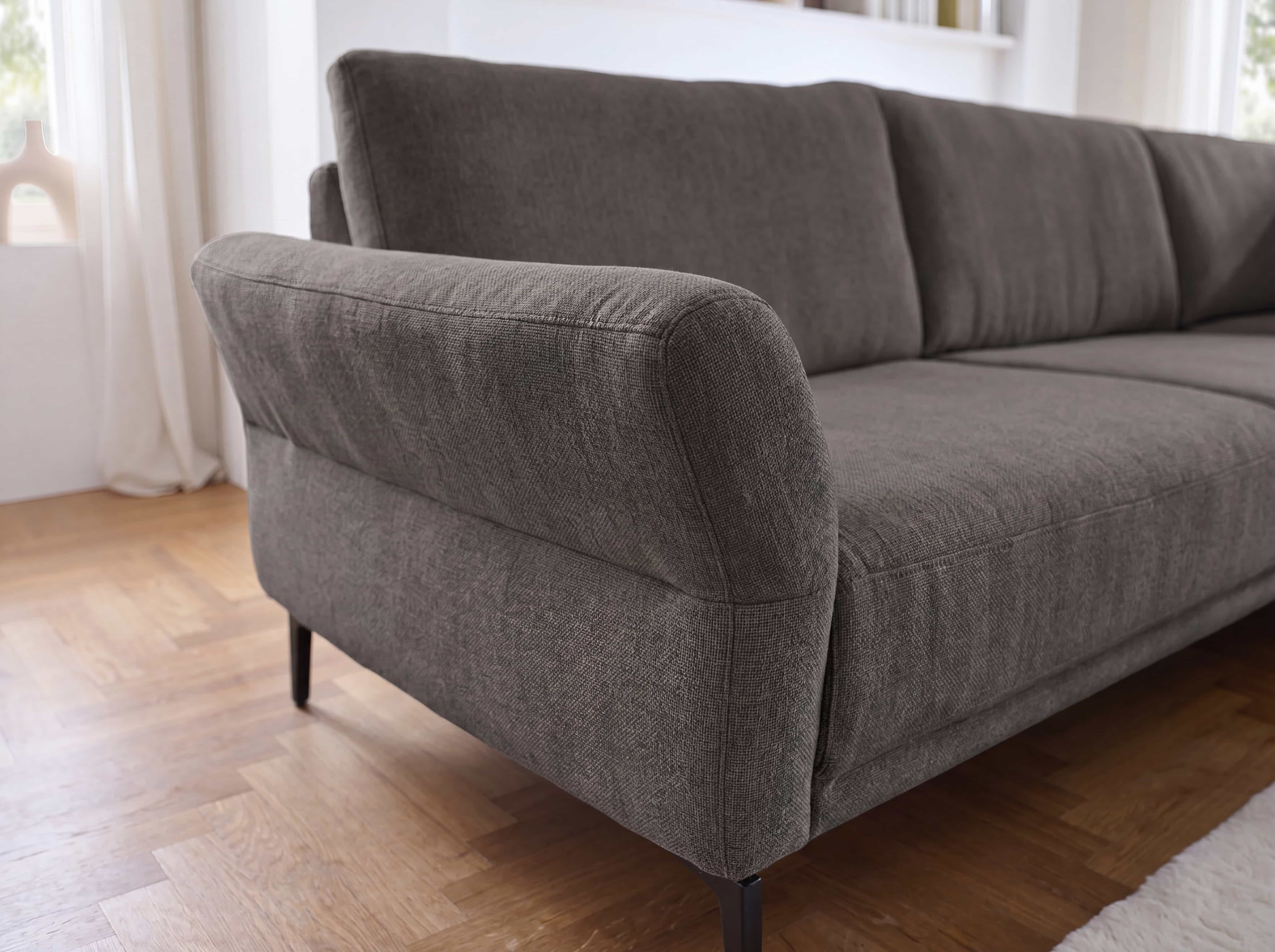 Ecksofa Kabs Polsterwelt mit grauem Stoffbezug, gepolsterter Rückenlehne und runden Armlehnen