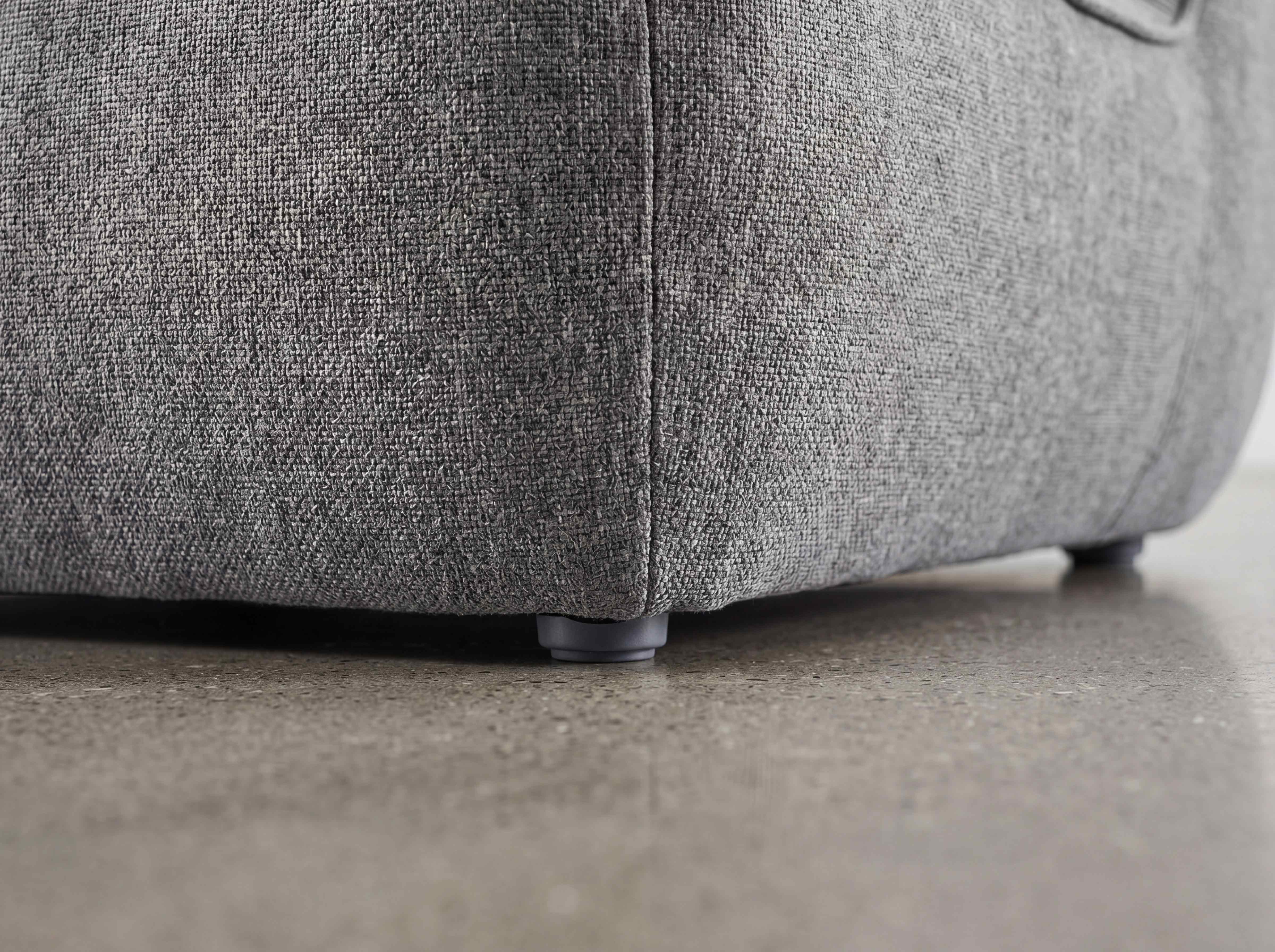 Ecksofa Hudson mit grauem Stoffbezug und niedrigen Kunststofffüßen, Nahaufnahme einer Ecke